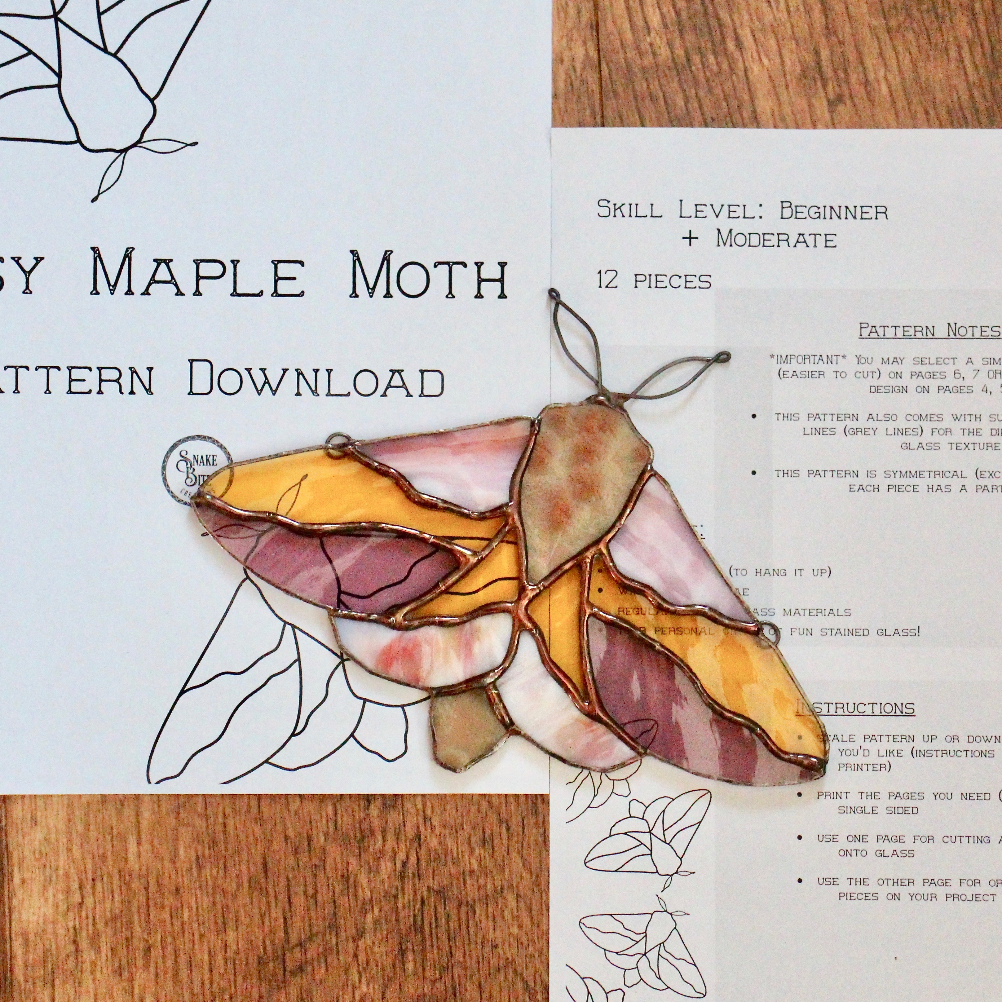 pink and yellow stained glass moth for a stained glass pattern download; a rosy maple moth